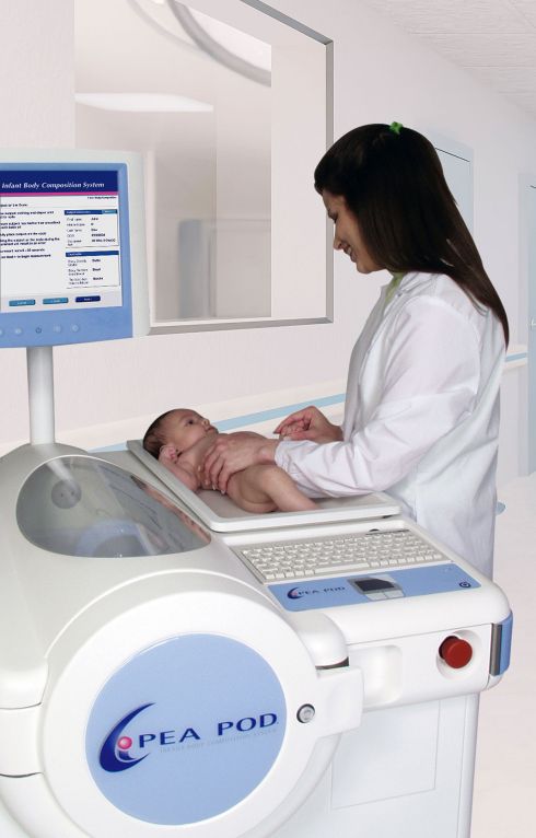 PEA POD - female doctor weighs a newborn